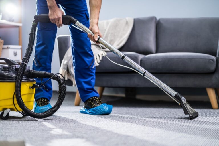 man vacuuming carpet